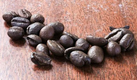 Fresh coffee beans on the old table Stock Photos