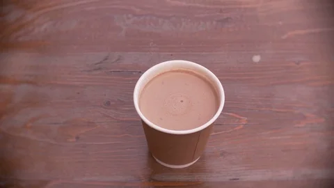 Fresh coffee in a disposable paper cup Stock Footage 76789595