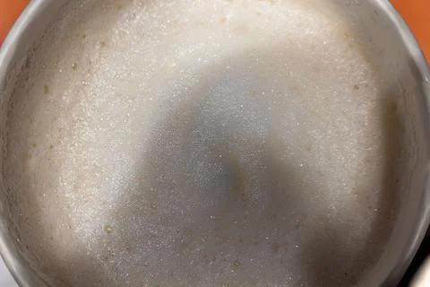 Fresh coffee foam with small bubbles in a white ceramic cup from above Stock Photos