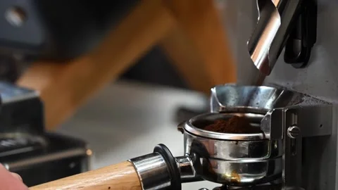 Fresh coffee grounds falling into espresso portafilter from commercial grin.. Stock Footage 339646266
