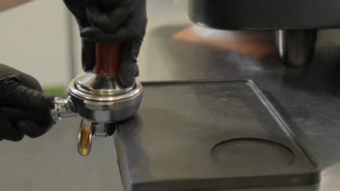 Fresh coffee tamping. Tamping freshly ground coffee into a horn. Stock Footage