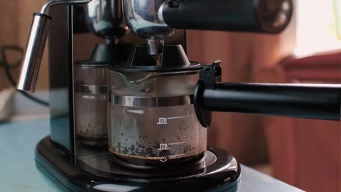 Fresh coffee is typed into a coffee maker glass Stock Footage 240982901