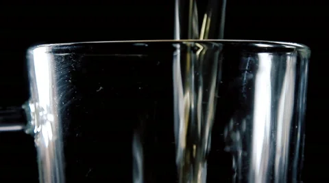 Fresh, cold, crisp beer being poured into a classic pint mug against a mottled Stock Footage 61602126