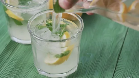 Fresh cold lemonade with mint and ice, outdoors shot, top view. Stock Footage 166049993
