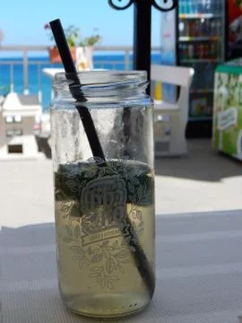 Fresh cold lemonade with mint leafs in the jar on the table Stock Photos