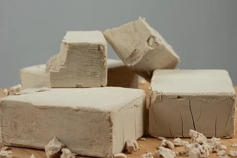 Fresh Compressed Yeast Blocks on Gray Background Stockfoto's