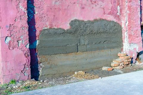 Fresh concrete patch in a brick wall Stock Photos