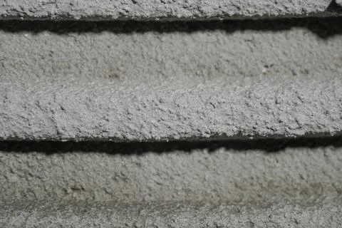 Fresh concrete tehture with patterns of notched trowel. Macro shot of grey Stock Photos