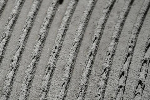 Fresh concrete tehture with patterns of notched trowel. Macro shot of grey Stock Photos