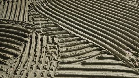 Fresh concrete texture with patterns of notched trowel. Macro shot of grey Stock Photos