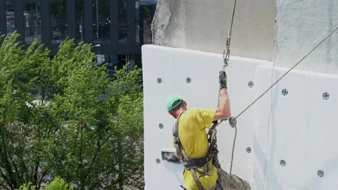 Fresh construction of external wall thermal insulation. Work at heights concept Stock Footage 133215558