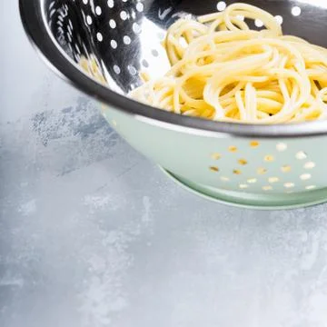 Fresh cooked spaghetti in stainless strainer Stock Photos
