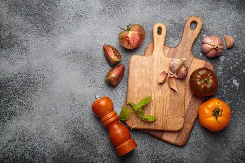 Fresh cooking ingredients lying on rustic kitchen countertop with cutting boards Stock Photos
