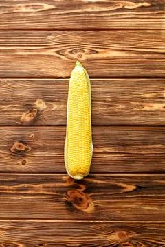 Fresh corn on cob on rustic wooden table. Top view. Stock Photos