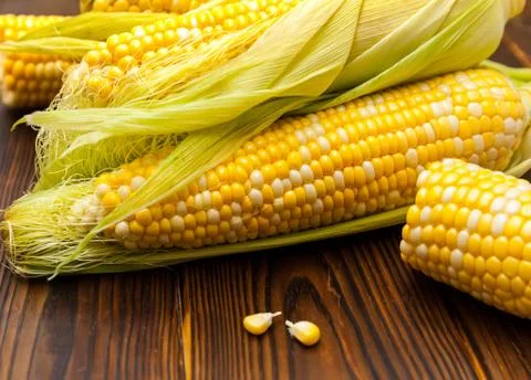 Fresh corn on cobs on rustic wooden table, closeup Stock Photos
