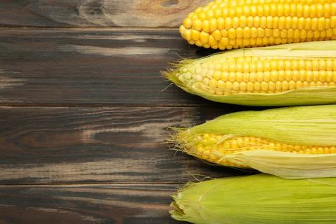 Fresh corn on cobs on rustic wooden table, closeup Stock Photos