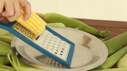 Fresh corn. Grating the corn to prepare hominy. Festa Junina. Stock Footage 129604192