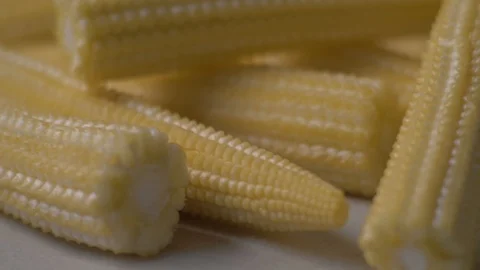 Fresh corns lie on the table. 4K. Food video. Close-up of fresh corn. Concept Stock Footage 105882871