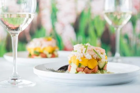 Fresh crab stack salad with mango and vegetables, served with white wine. Stockfoto's