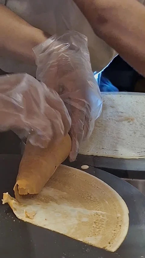 Fresh Crepe Being Rolled by Hand at a Street Food Stall Vídeos de archivo 340757892