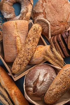 Fresh, crispy bread of various types and wheat close-up. Top view. Stock Photos
