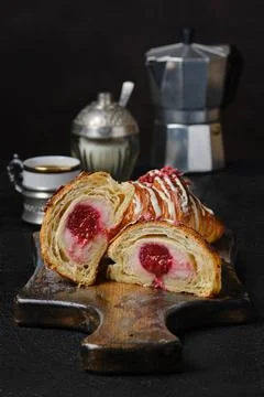 Fresh croissant cut on half showing raspberry filling Stock Photos