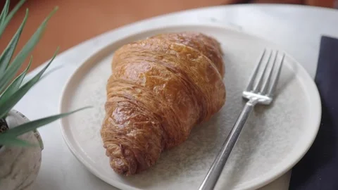 Fresh croissant on a plate with a fork 스톡 동영상 343479777