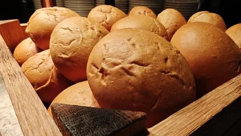 Fresh Crusty Bread Rolls Displayed in Wooden Basket at Bakery Buffet Stock Photos