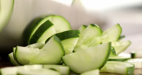 Fresh cucumber is cut into small slices. Close-up. Stock Footage 250482878