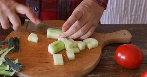 Fresh cucumber cut using sharp knife, close-up, steadicam Stock Footage 114719449