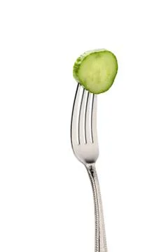Fresh cucumber slice on fork isolated on white. healthy lifestyle concept 库存照片