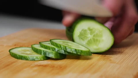 Fresh Cucumber Sliced with Kitchen Knife on Cutting Board. Stock Footage 346861449