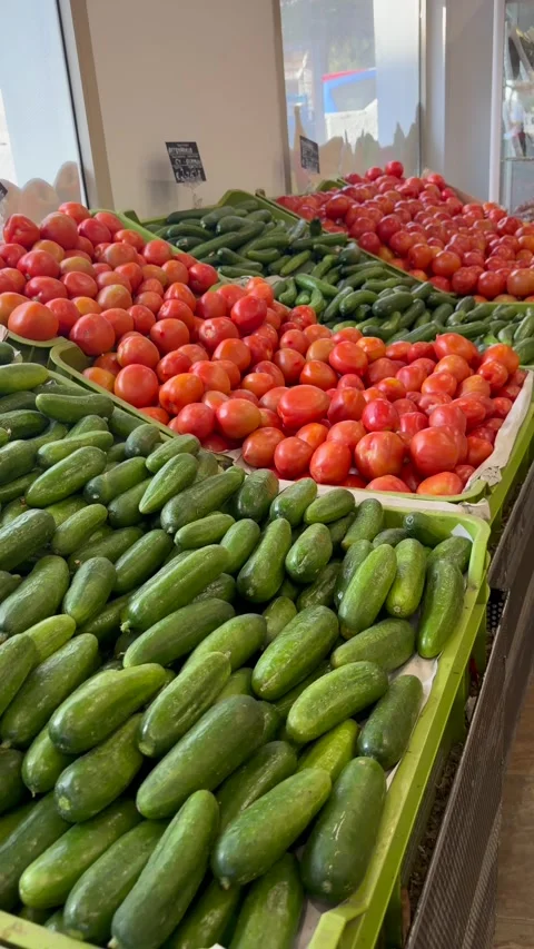 Fresh cucumbers and tomatoes displayed on supermarket shelves. Healthy Stock Footage 334704369