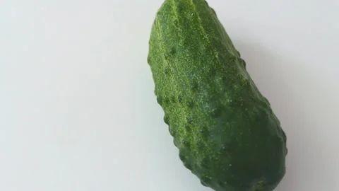 Fresh cucumbers rotate on white background Stock Footage 202107563