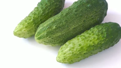 Fresh cucumbers rotate on white background Stock Footage 202107612