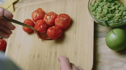 Fresh culinary view of grilled tomatoes collected on a wooden board Stock Footage 342152693