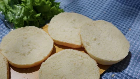 Fresh Cut Burger Buns and Green Lettuce Prepared for Outdoor Picnic 스톡 동영상 341997935