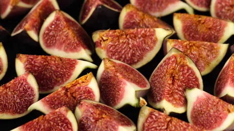 Fresh cut figs close up rotating on black background Stock Footage 139799136
