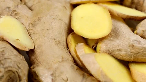 Fresh cut ginger root slices circle rotation close up Stock Footage 276489551