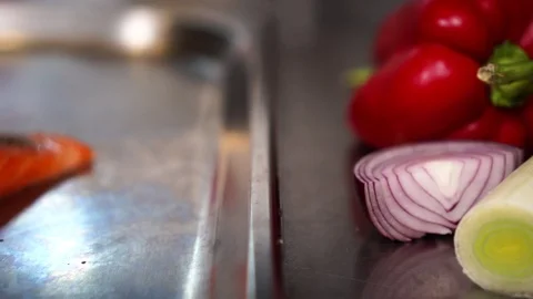 Fresh cut healthy vegetables on kitchen table next to beautiful raw fish salmon Stock-Footage 106982437