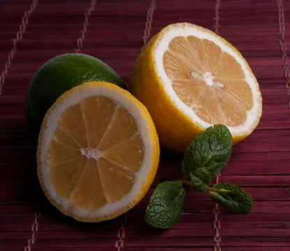 Fresh cut lemon and lime with mint Stock Photos