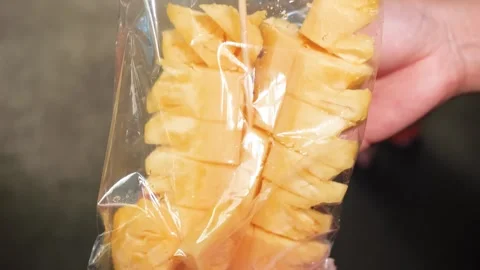 Fresh Cut Pineapple Slices on a Skewer inside a Clear Plastic Bag Stock Footage 345651059