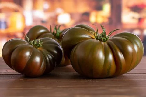 Fresh dark tomato primora with rustic kitchen Stock Photos