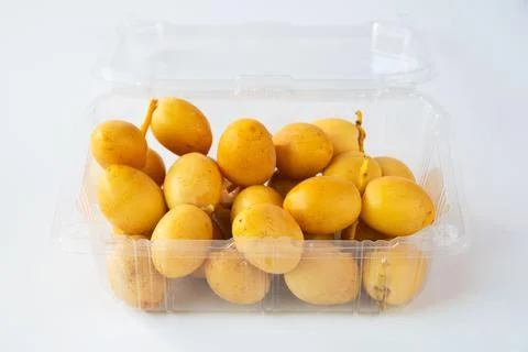 Fresh date palm fruit in plastic package on white background Stock Photos
