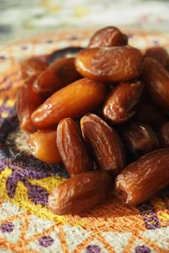 Fresh dates on a colorful textile background Foto stock