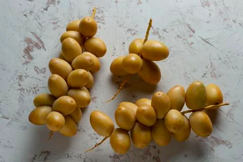 Fresh dates fruit on texture white background Stock Photos