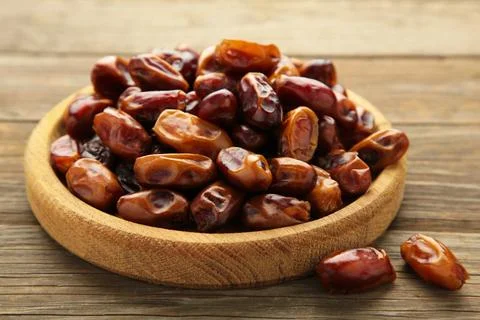 Fresh dates on plate on grey background. Close up Stock Photos