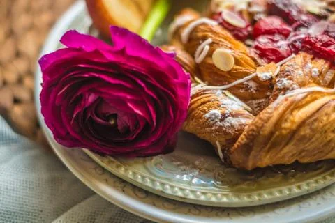 Fresh delicious buns with raspberry jam for the breakfast with a rose on vi.. Stock Photos