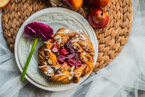 Fresh delicious buns with raspberry jam for the breakfast with a rose on vi.. Stock Photos