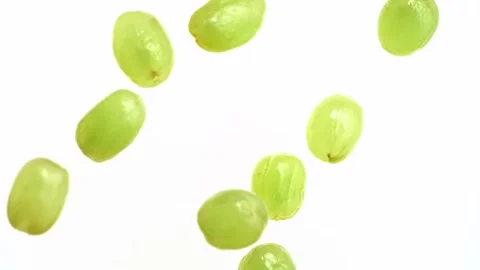 Fresh delicious green grapes falling into white creamy yogurt milk creating Stock Footage 340951654